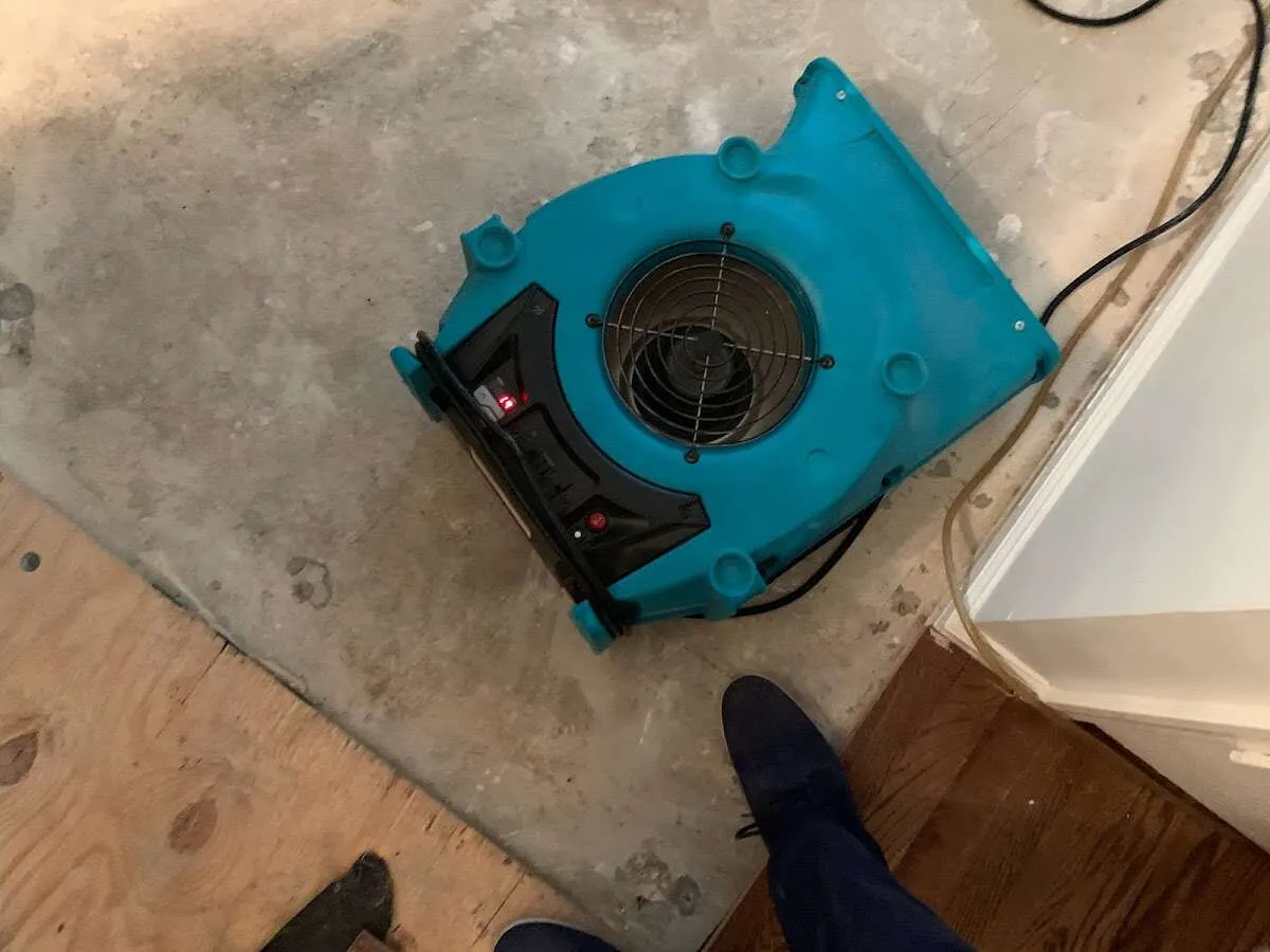 Air mover drying subfloor during Leak Detection & Repair in Huron